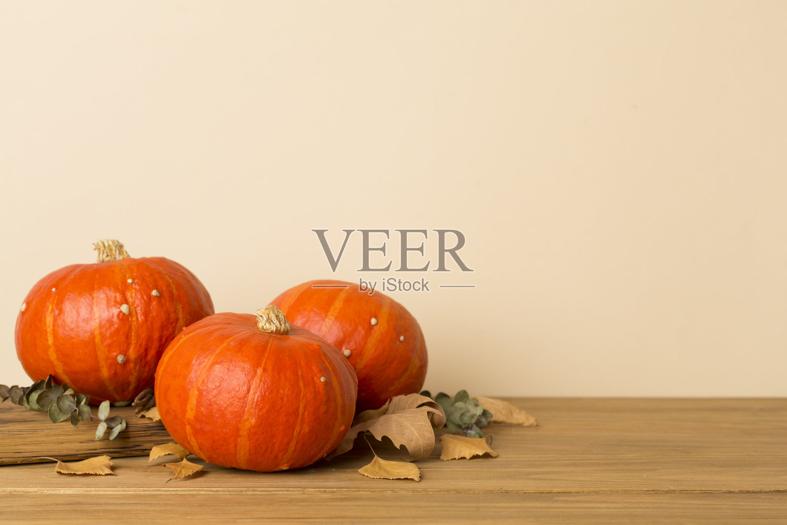 Orange pumpkins with autumn decor on wooden table照片摄影图片