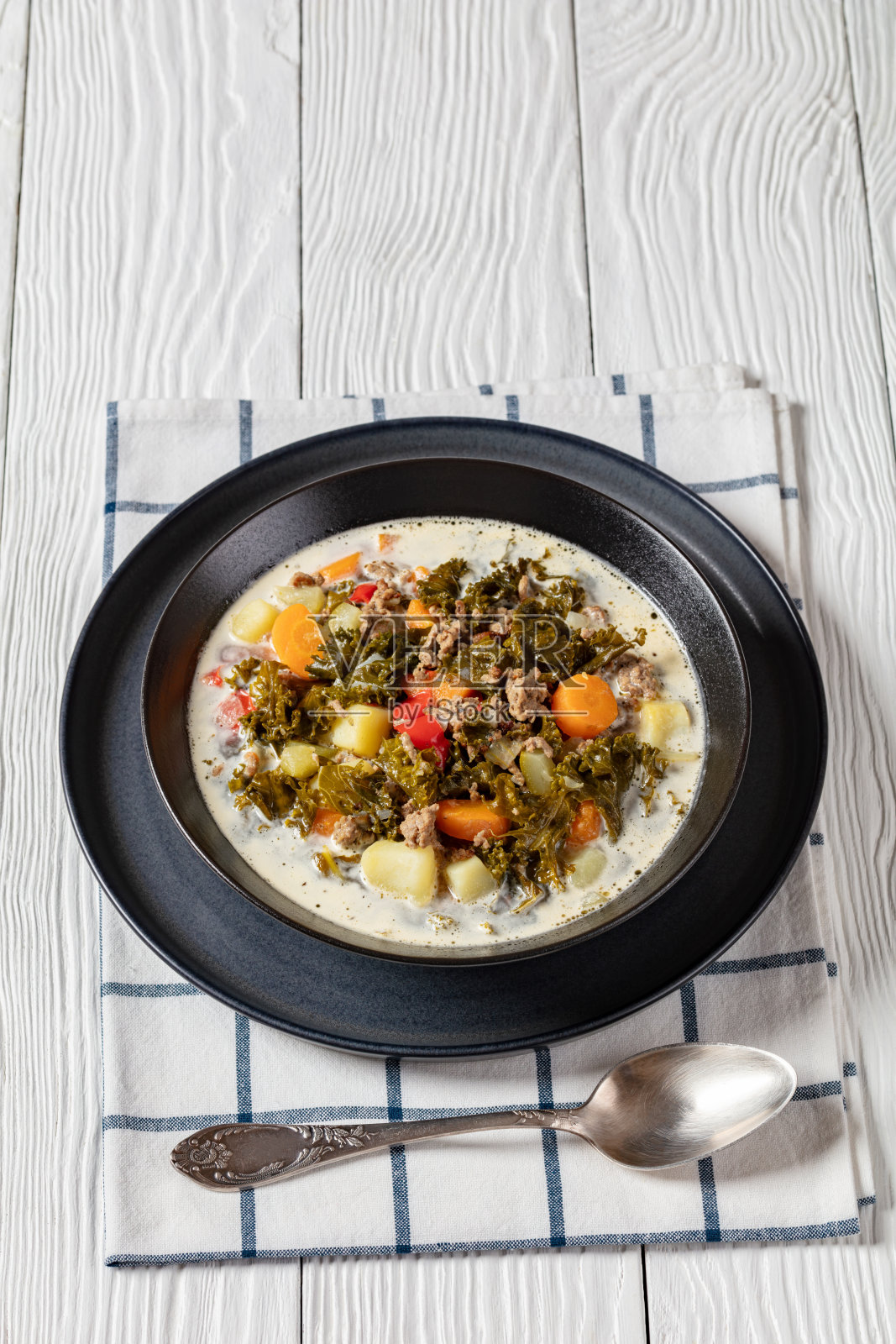 黑碗里的牛肉蔬菜羽衣甘蓝汤照片摄影图片