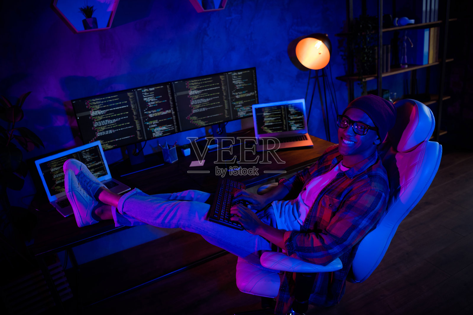 全身俯视肖像，网络设计师坐在椅子上，夜班在商务中心室内使用键盘写作照片摄影图片