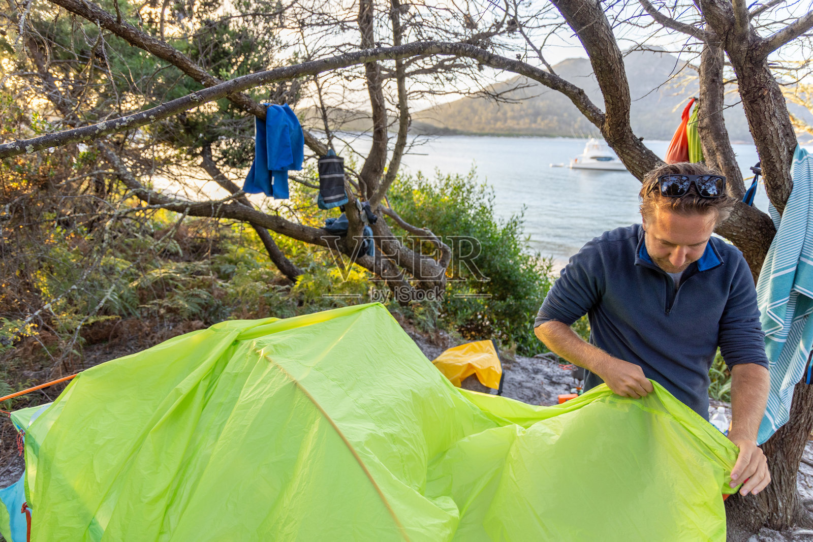 男子在海滩附近搭建帐篷照片摄影图片