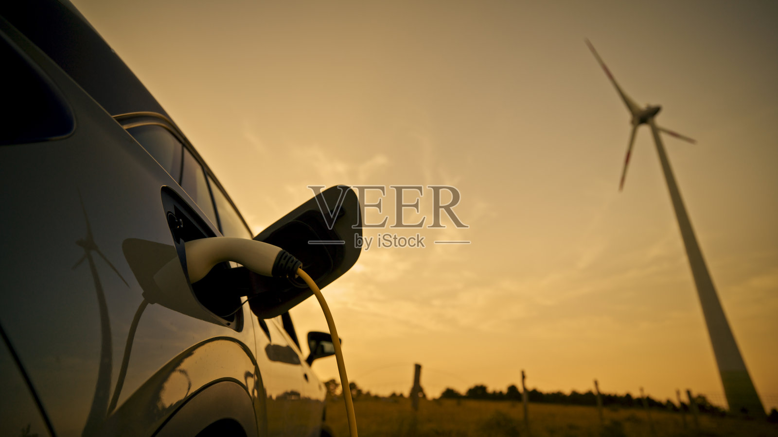 风力发电机为电动车充电照片摄影图片