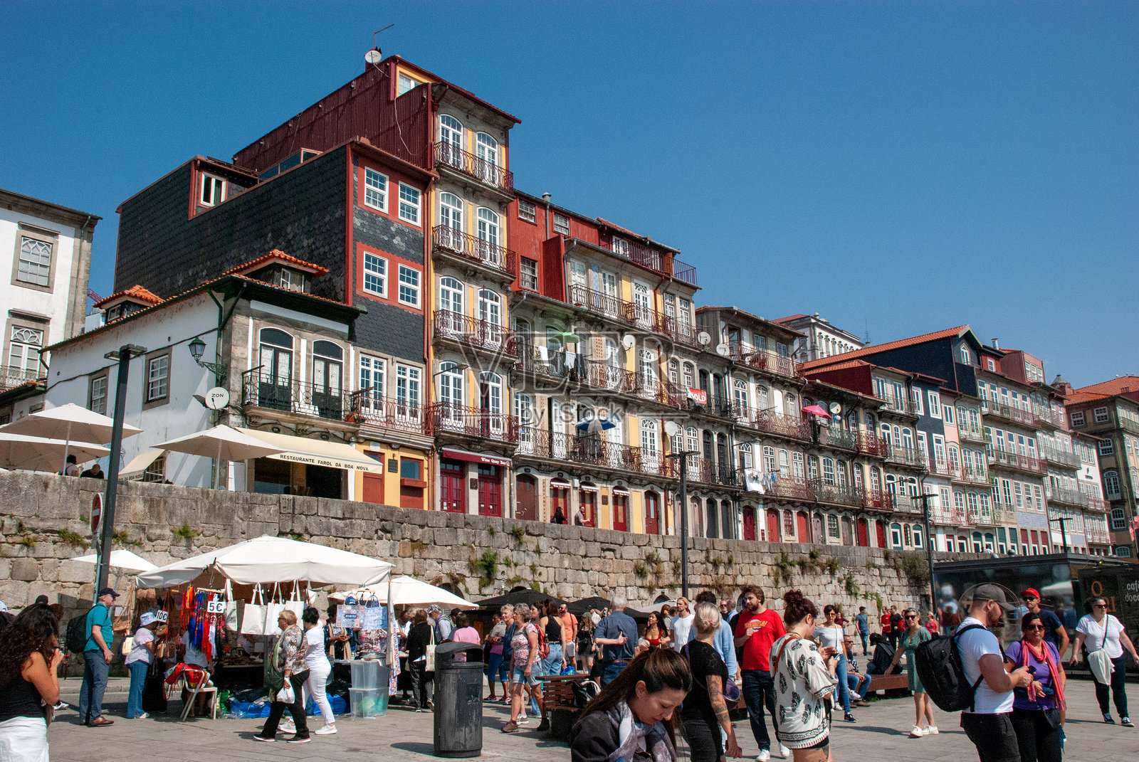 大众旅游：沿着拥挤的海滨长廊俯瞰葡萄牙波尔图杜罗河上的著名建筑照片摄影图片