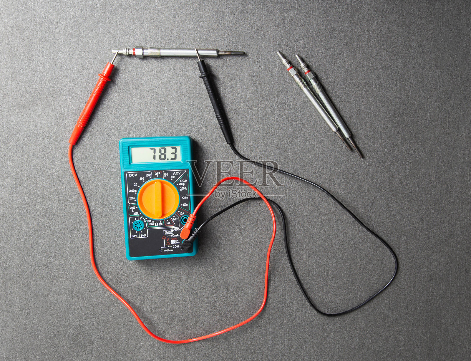 使用万用表检查预热塞的可服务性。预热塞电压电阻。现代加热元件特写。照片摄影图片