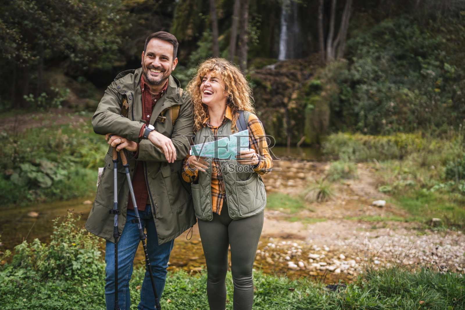 徒步旅行的情侣背包客在森林中探险并查看地图寻找路线照片摄影图片