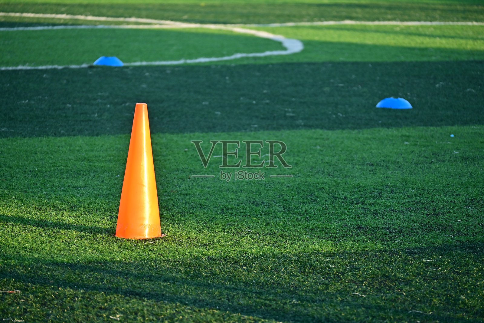 人工草坪足球场上放置着橙色训练锥。照片摄影图片