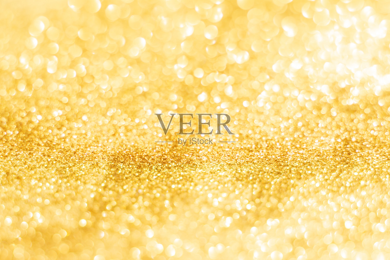 金色闪光虚化纹理背景。金色圣诞抽象背景照片摄影图片