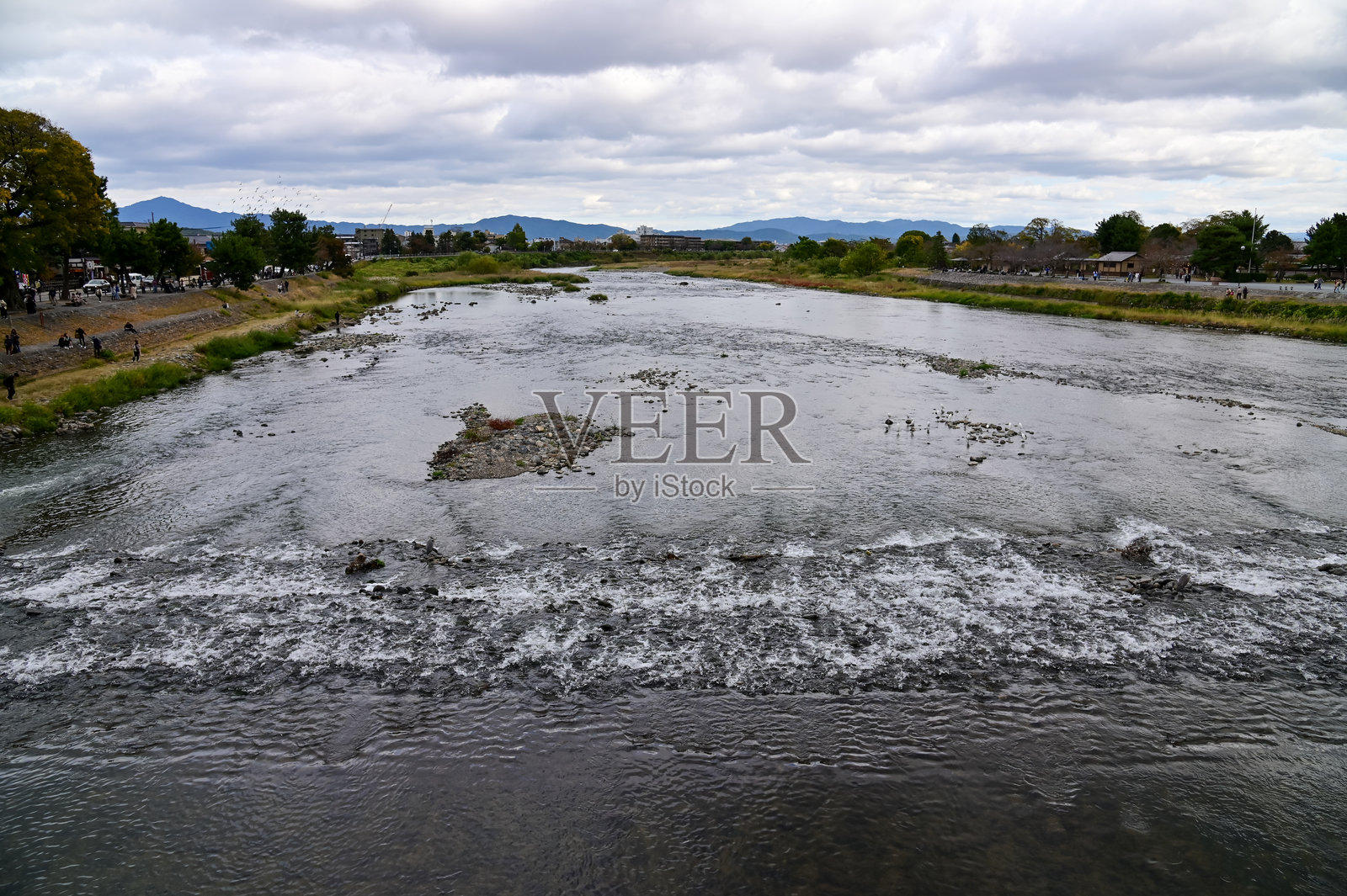 从京都的渡月桥俯瞰桂川秋景。照片摄影图片