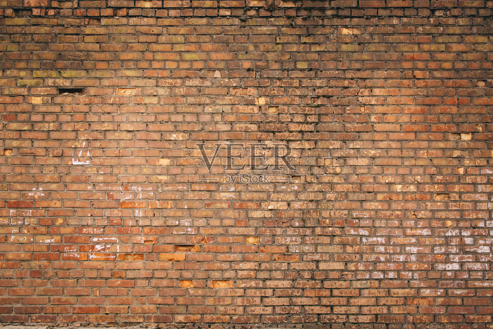破旧的黄红砖墙。可用作背景或海报。照片摄影图片