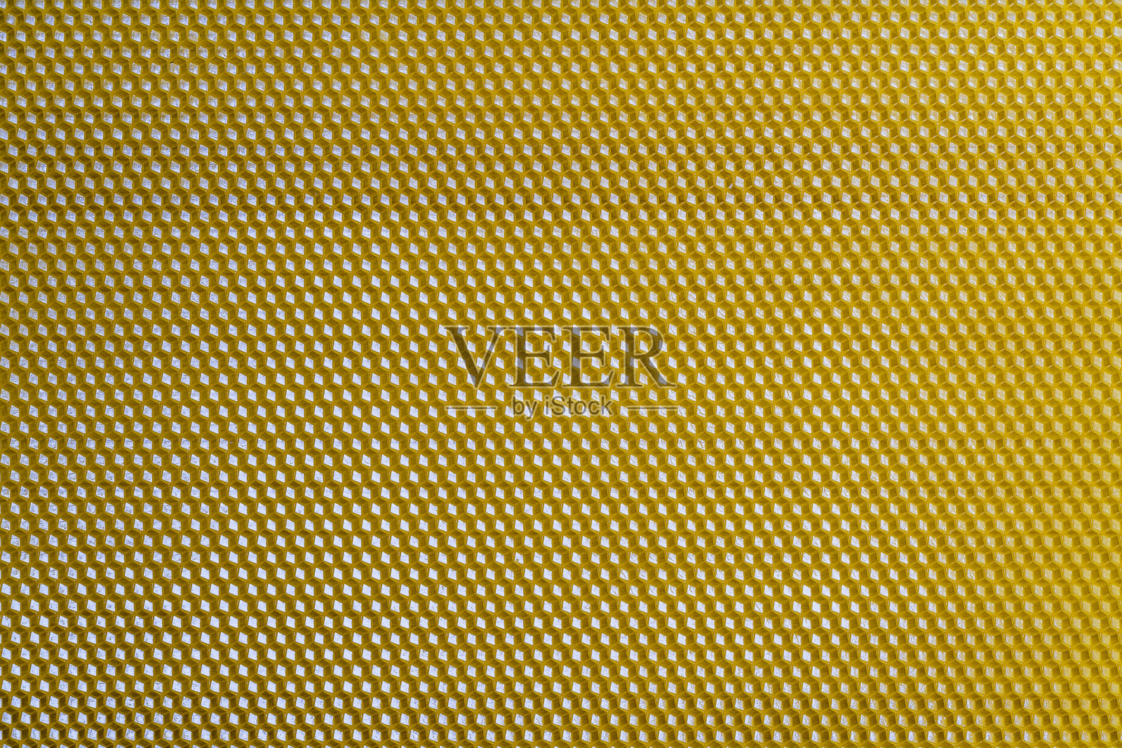 蜂巢中填满蜂蜜的蜂蜡蜂巢的背景纹理和图案。蜂蜡是构建蜂巢的人工基础，蜂窝的蜡片。照片摄影图片