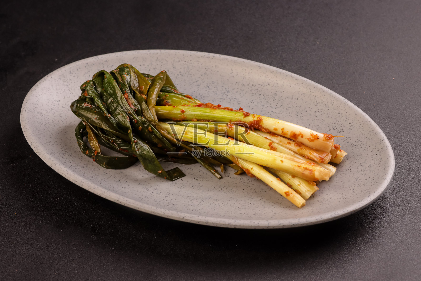 葱油泡菜放在盘子里。照片摄影图片