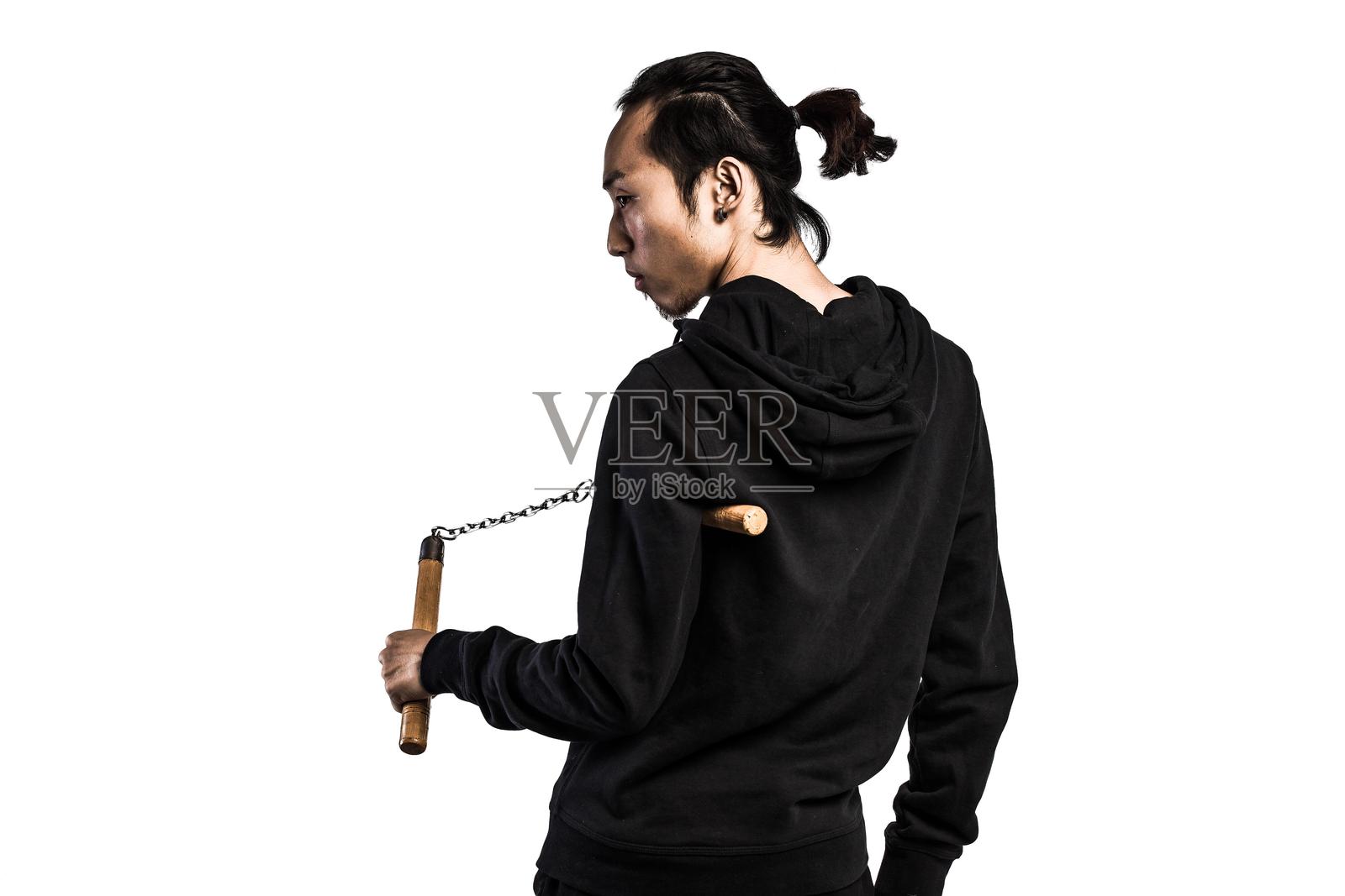 亚洲男子手持一对双节棍照片摄影图片