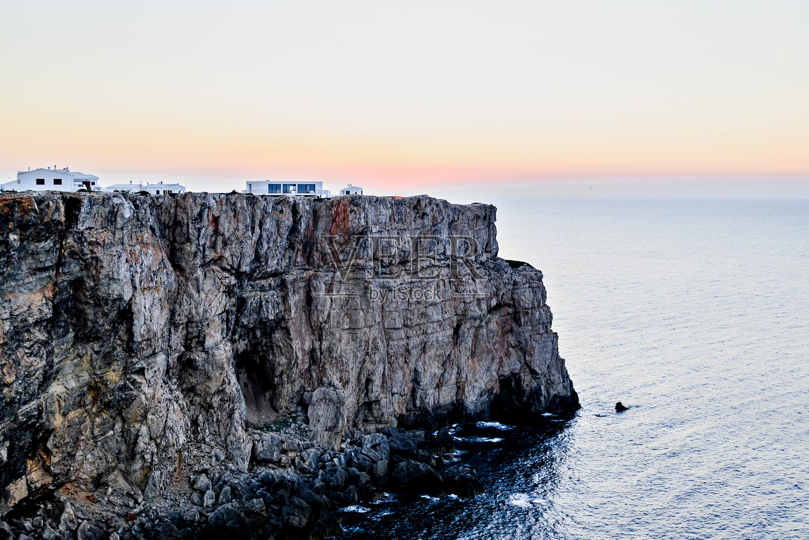 美丽的日落，橙色的天空映衬着梅诺卡岛（巴利阿里群岛）的海滩。自然风光。照片摄影图片