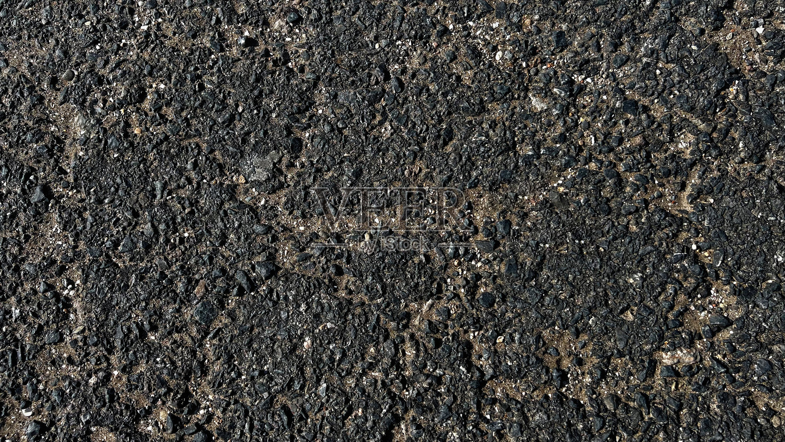 沥青路面纹理。旧沥青背景纹理特写。用于设计的抽象背景。照片摄影图片