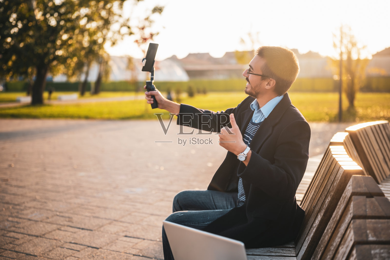 商人户外录制视频时竖起大拇指照片摄影图片