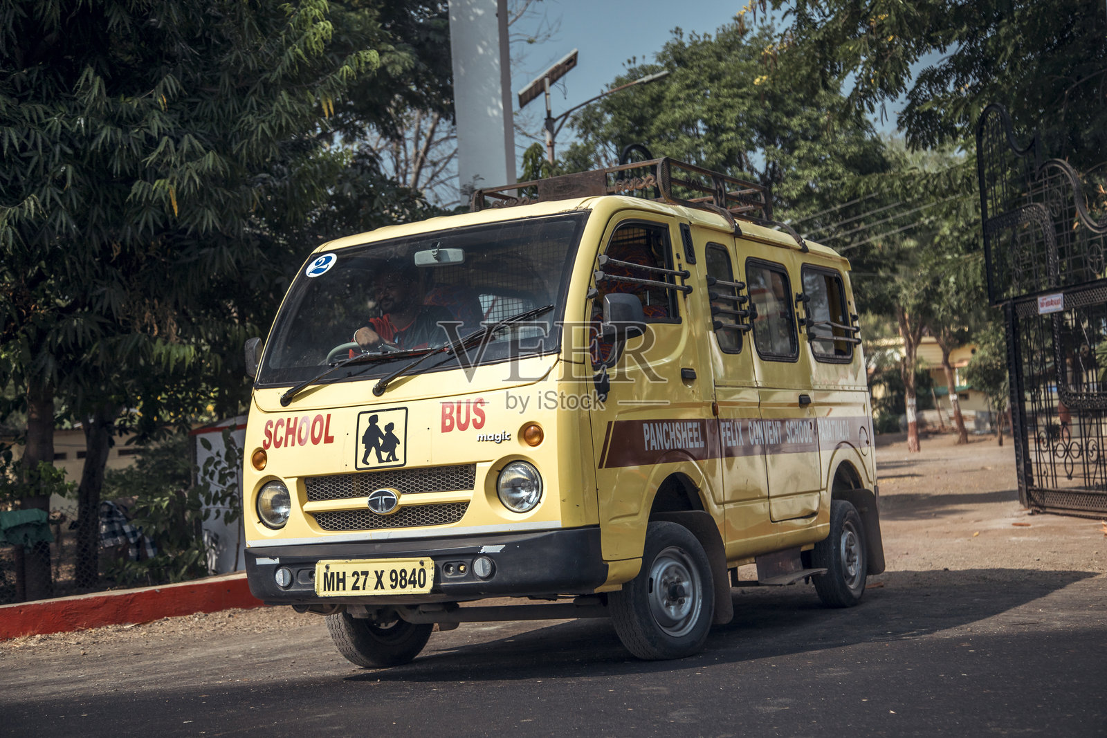 黄色校车在城市外接送学生照片摄影图片
