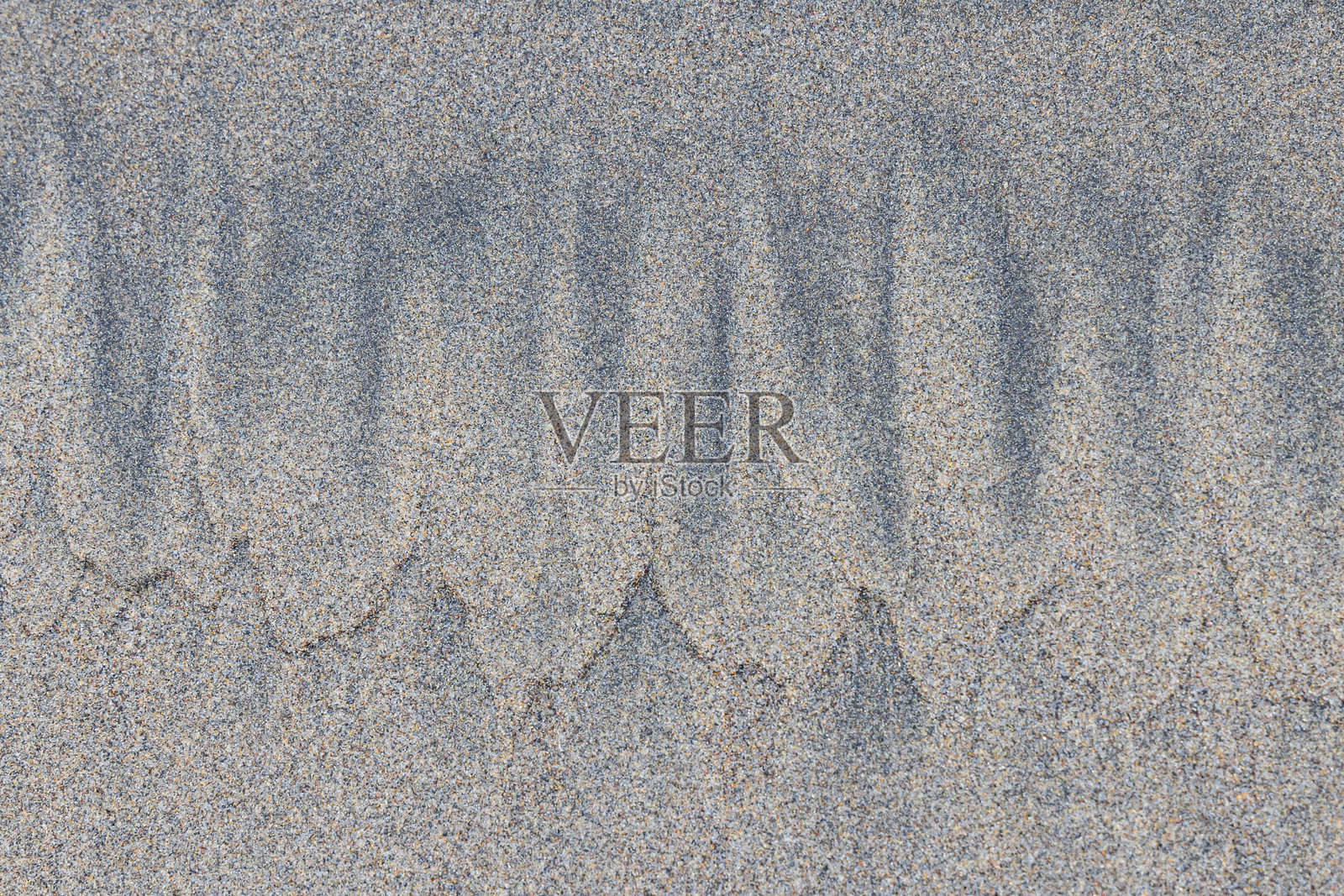 海滩上的沙子图案。照片摄影图片