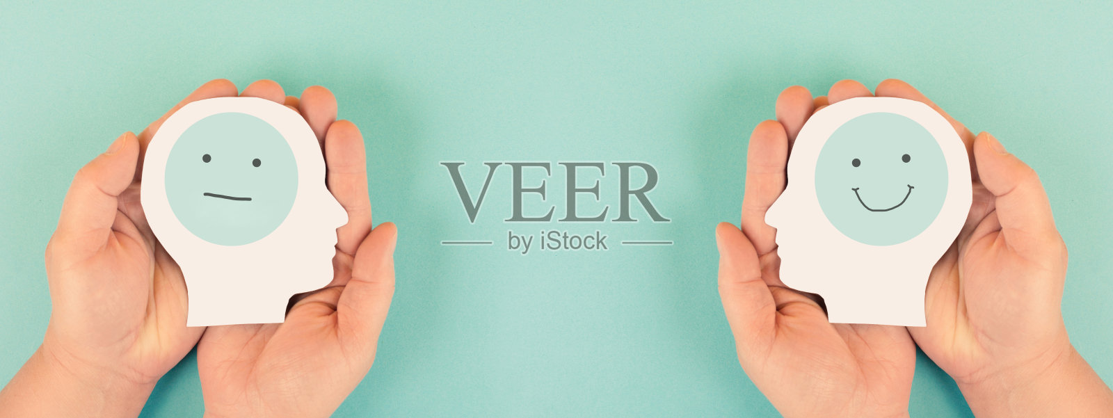 手握着一个悲伤和快乐面孔的头，心理健康概念，积极与消极思维，抑郁，支持与情感，分裂人格照片摄影图片