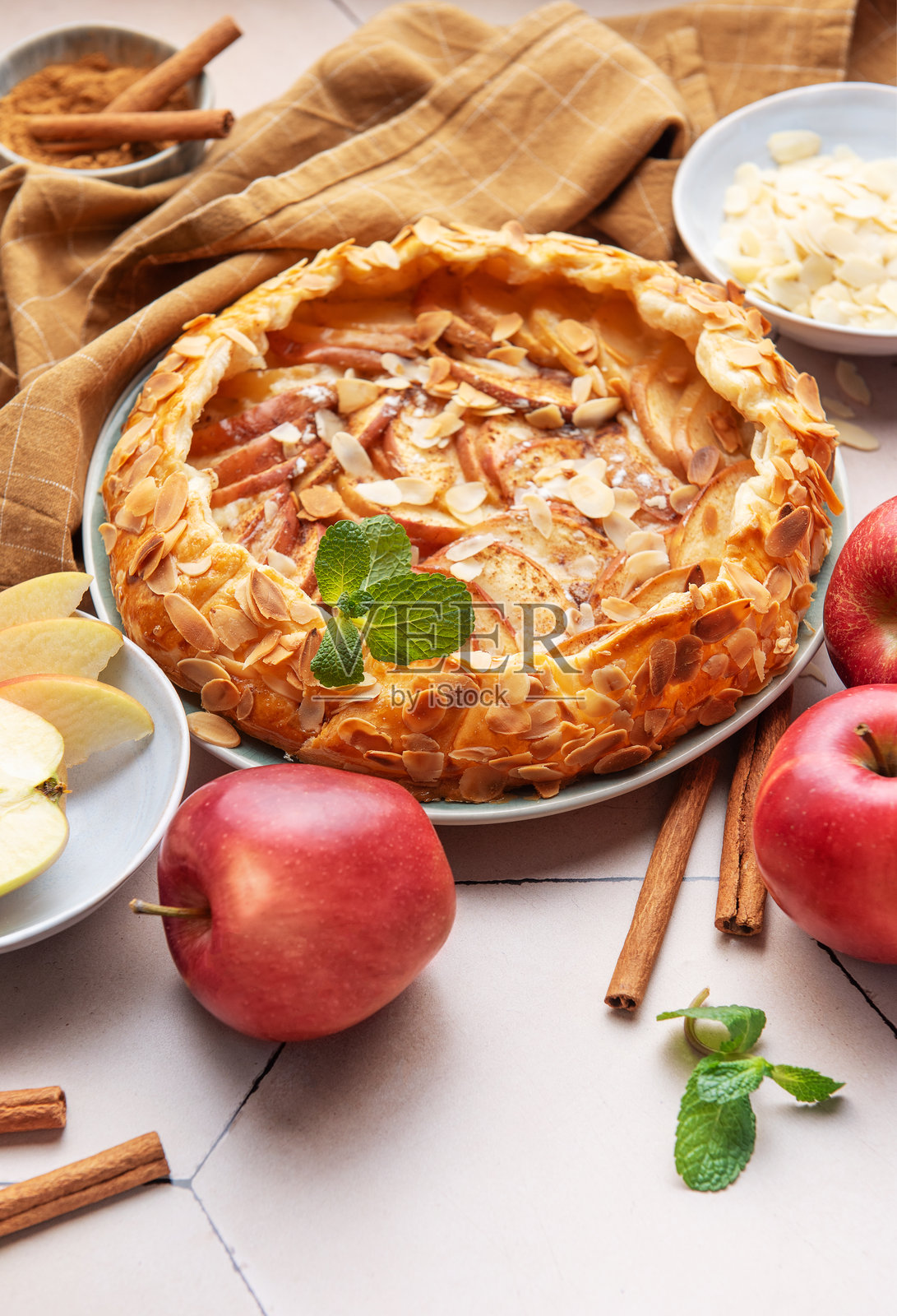 美味的自制苹果塔，配有新鲜苹果、杏仁片和香料照片摄影图片