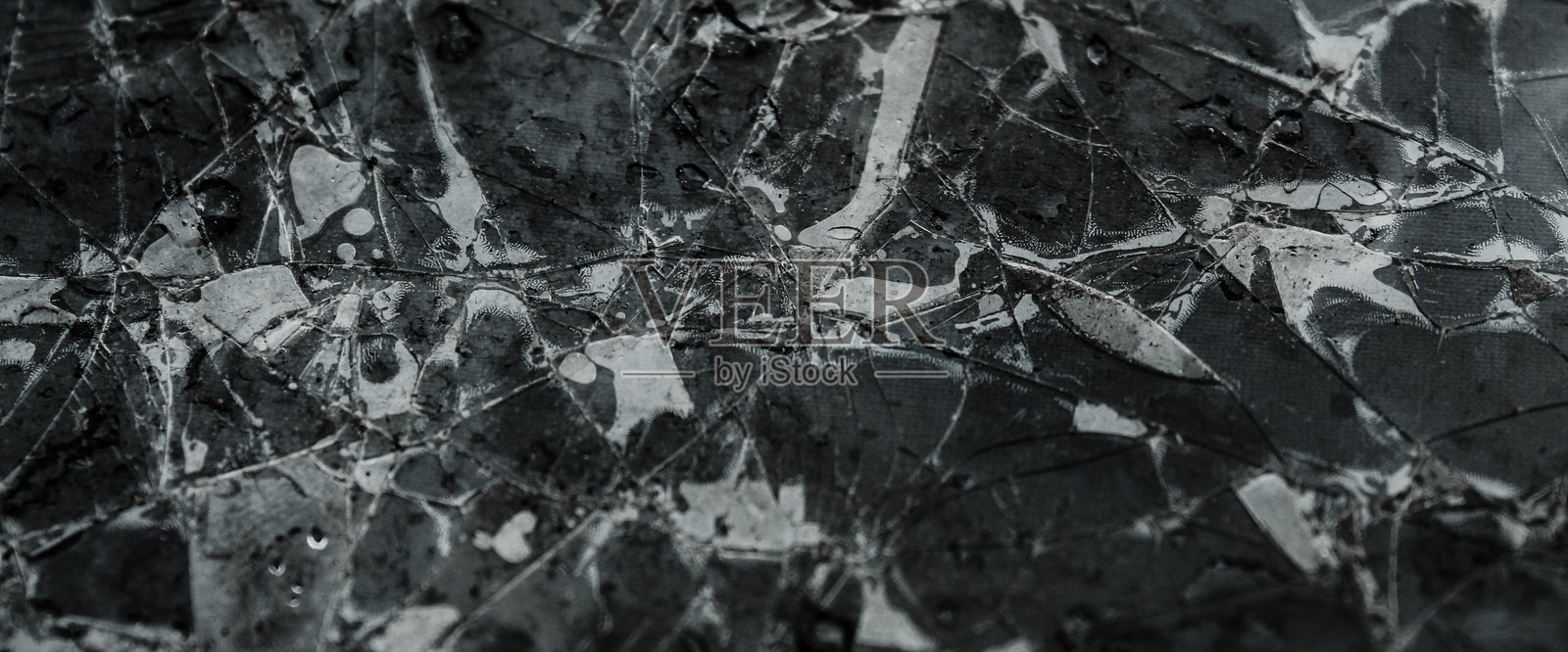 破裂玻璃上的纹理。玻璃损坏。裂纹质感。玻璃背景。照片摄影图片