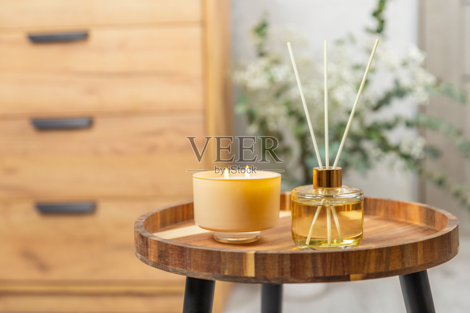 木桌上的芳香藤条空气清新剂。具有天然水果、花香和香料香气的扩散器。室内香氛。奢华的家用香水。橙子、青柠、咖啡、肉桂、八角、香草和兰花。照片摄影图片