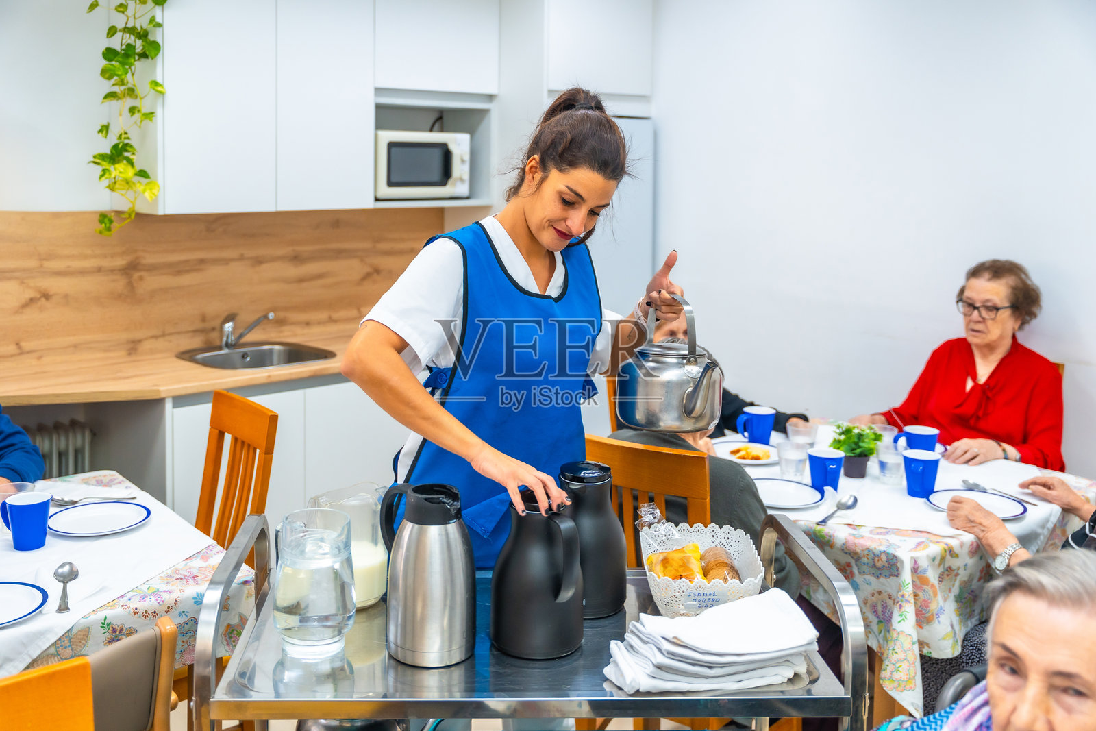 护士在老年病房的餐厅准备咖啡照片摄影图片