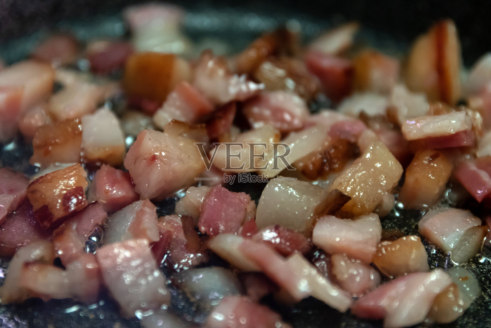 在平底锅中煎炸的香脆培根丁，非常适合为您厨房中的各种菜肴增添风味。照片摄影图片