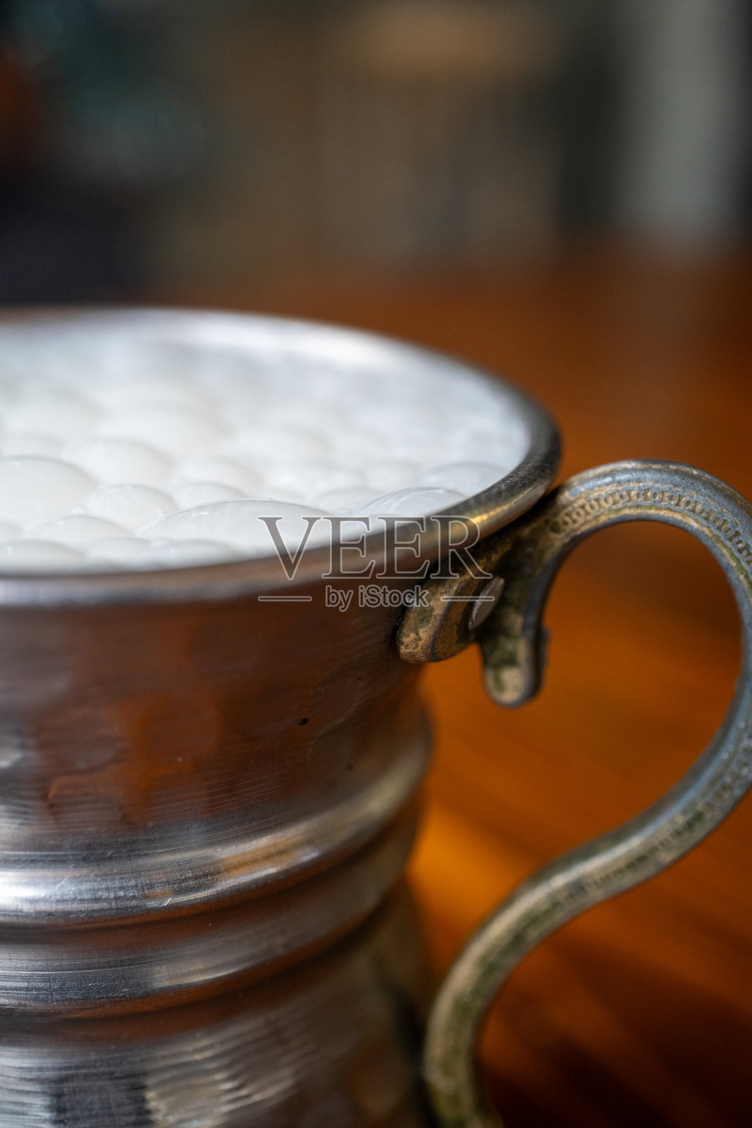 灰色传统金属杯中的土耳其酸奶饮料照片摄影图片