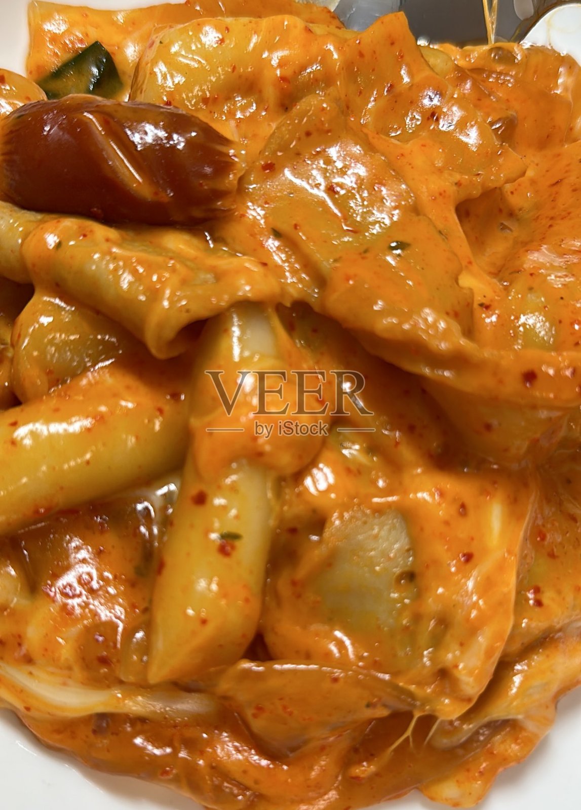 辣炒年糕，最著名的韩国街头小吃。辣味、嚼劲十足的米糕配上美味的酱汁。照片摄影图片