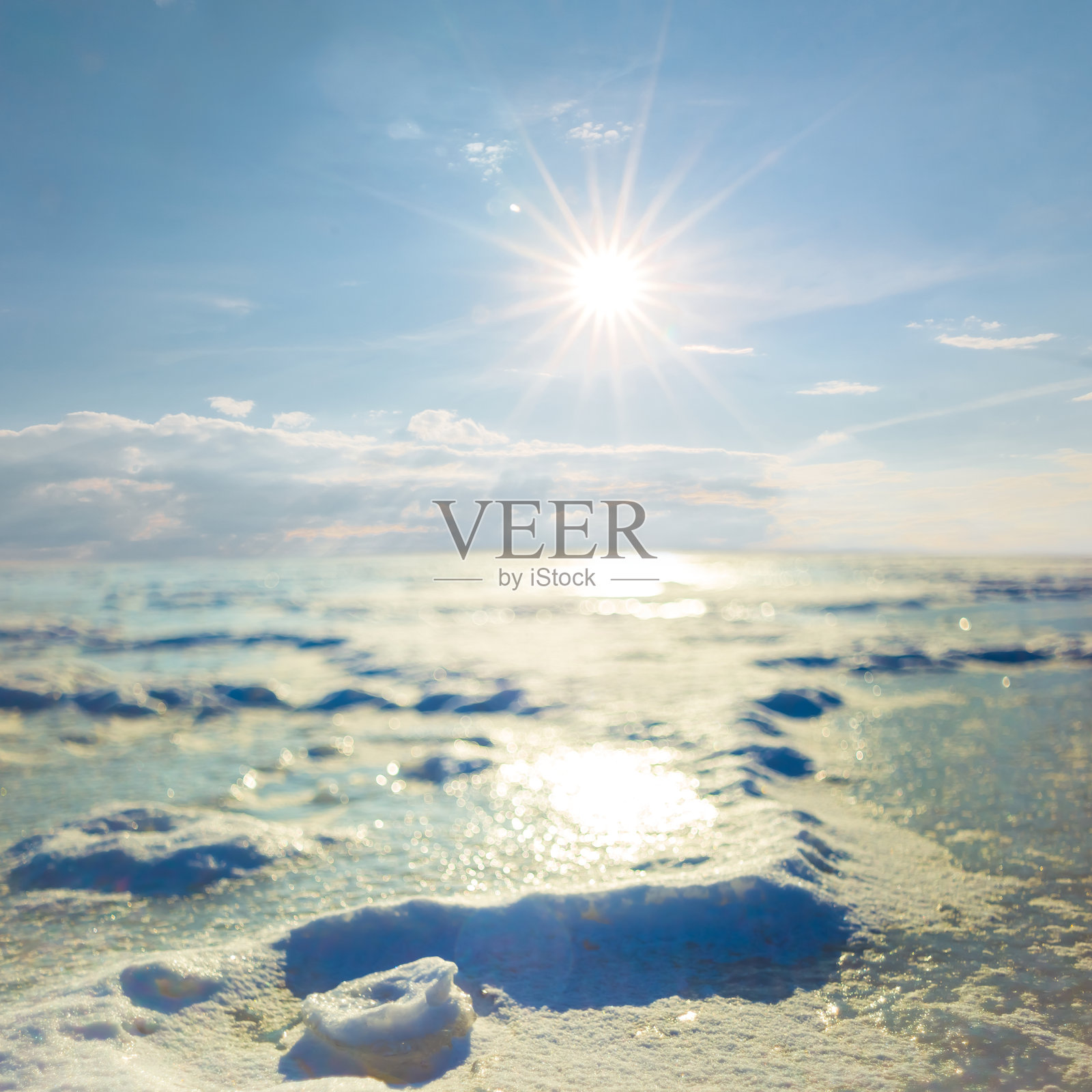 阳光闪烁下的雪覆盖冰冻平原特写，冬季户外背景照片摄影图片