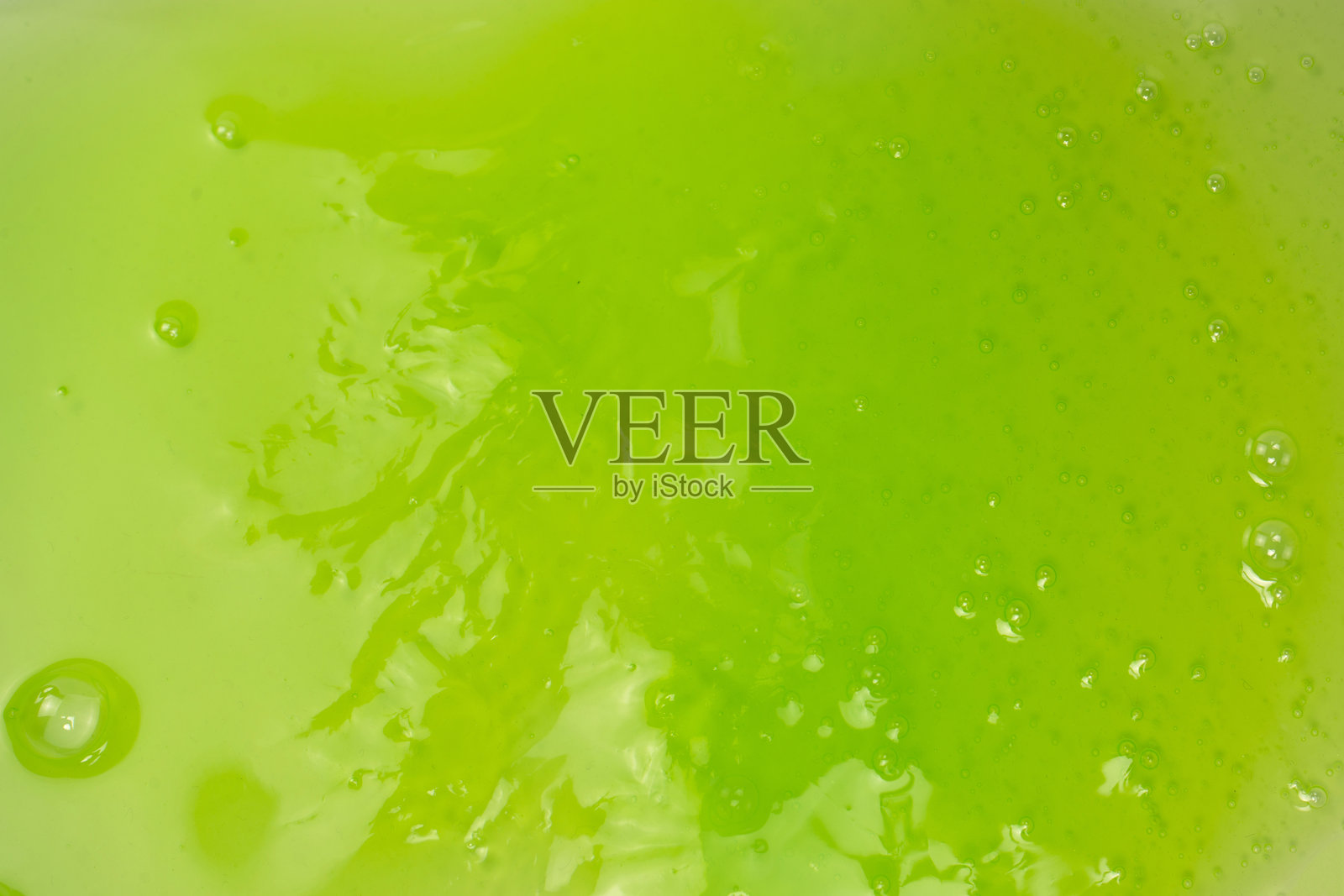 绿色粘液玩具作为背景。照片摄影图片