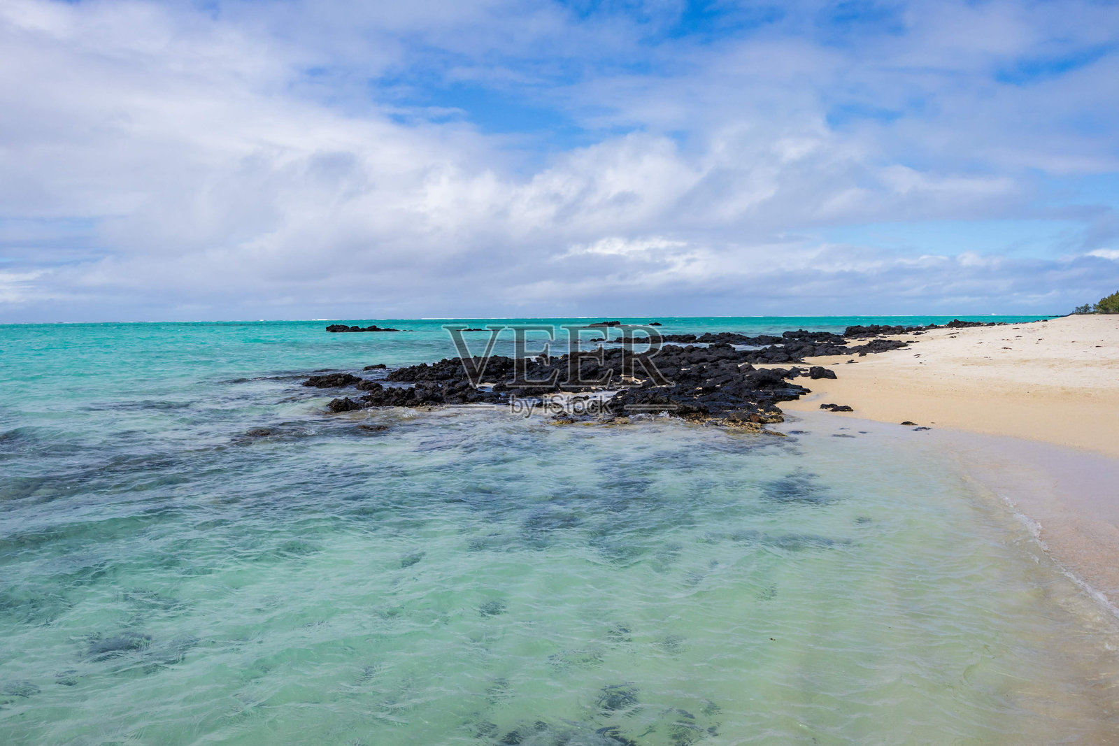 毛里求斯塞尔岛的宁静海滩景观，清澈的绿松石水和黑色火山岩照片摄影图片