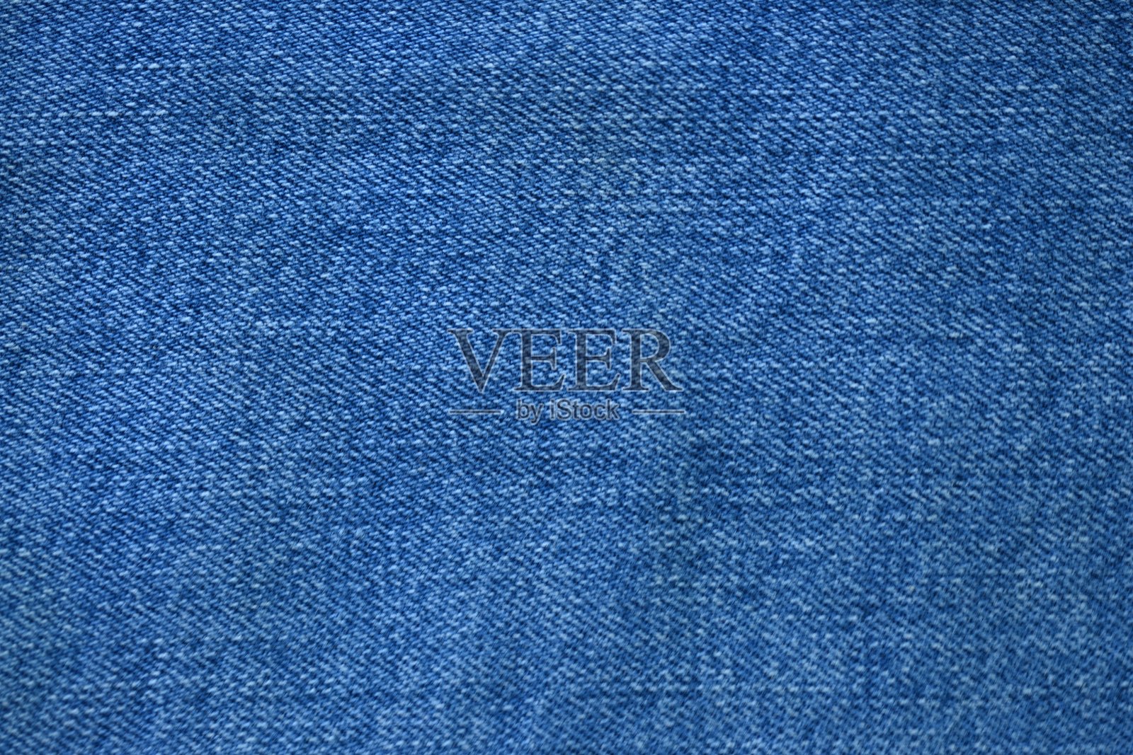 宏观蓝色牛仔布纹理，蓝色牛仔布纹理作为背景的特写照片，从上方拍摄。照片摄影图片