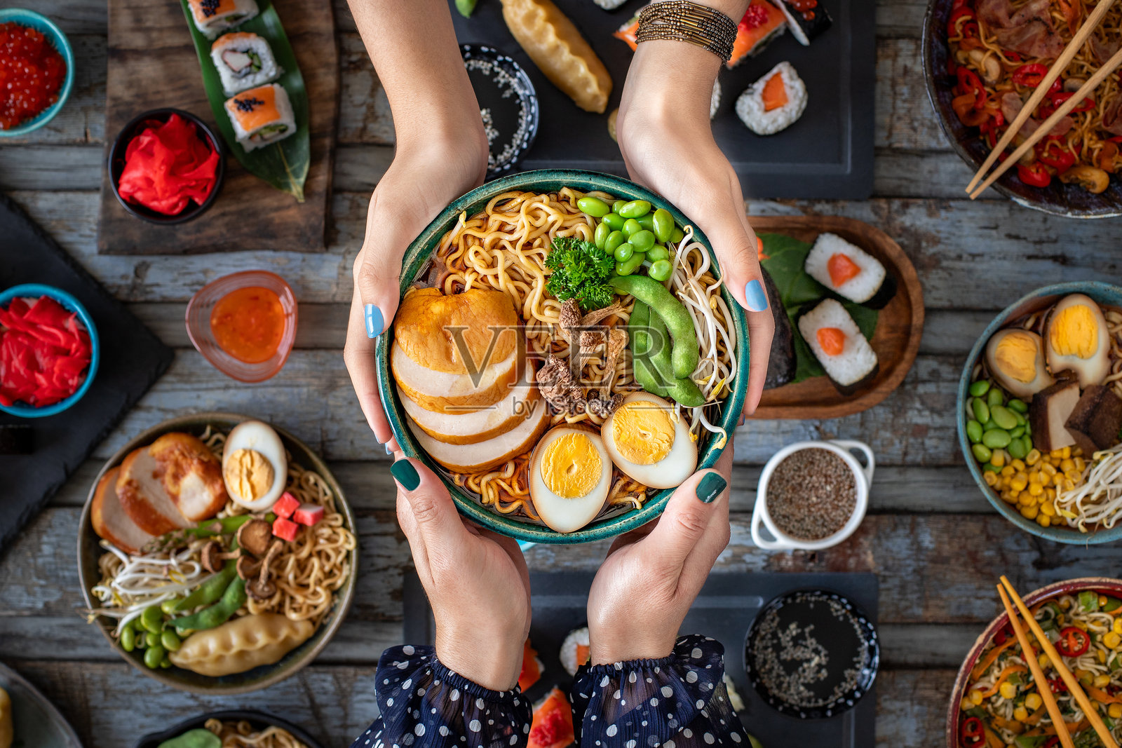 两位女性手中的拉面。豚骨拉面碗。照片摄影图片