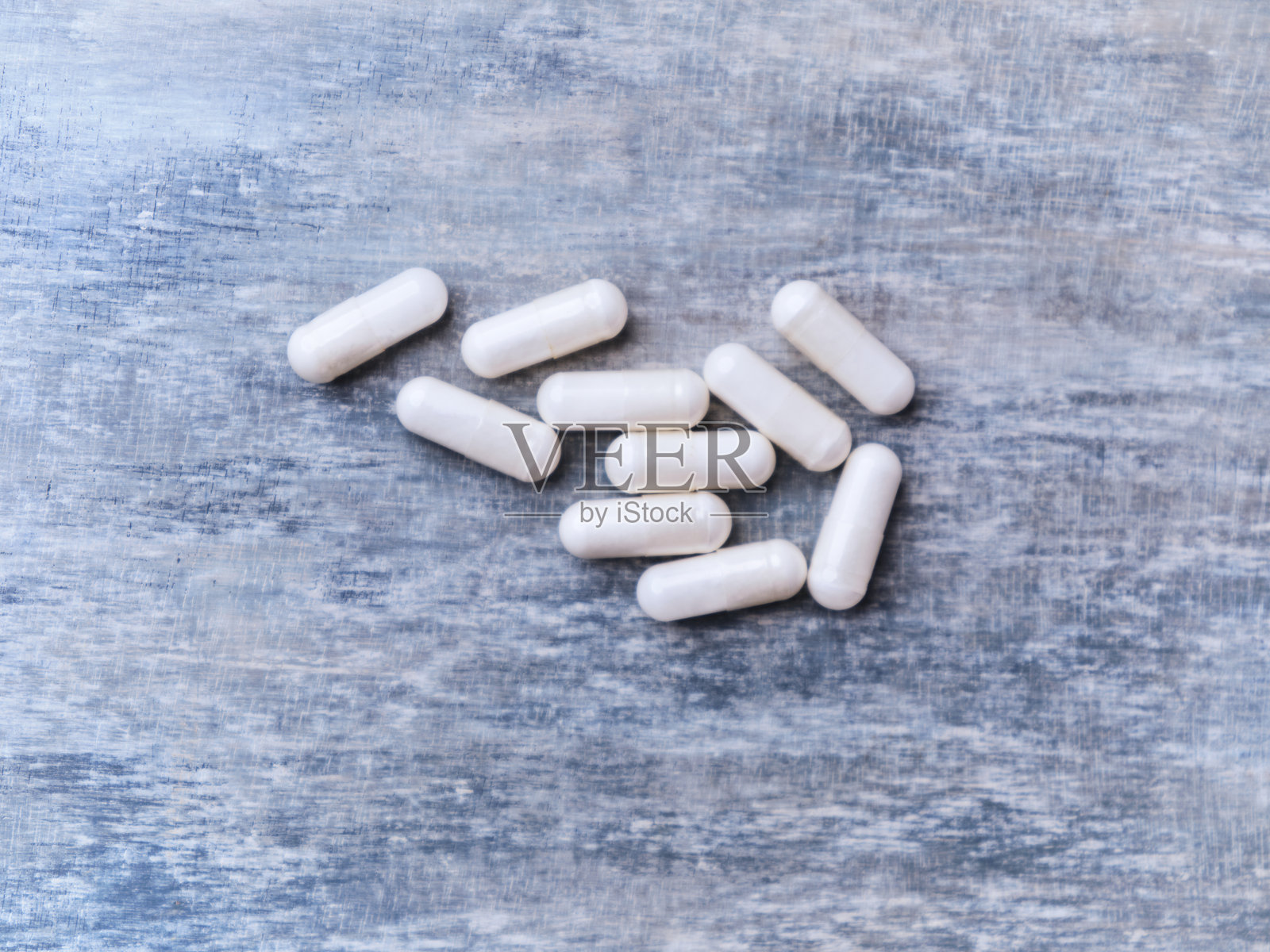 β-丙氨酸胶囊。木质背景上的健美食品补充剂。柔焦。特写。留白。照片摄影图片