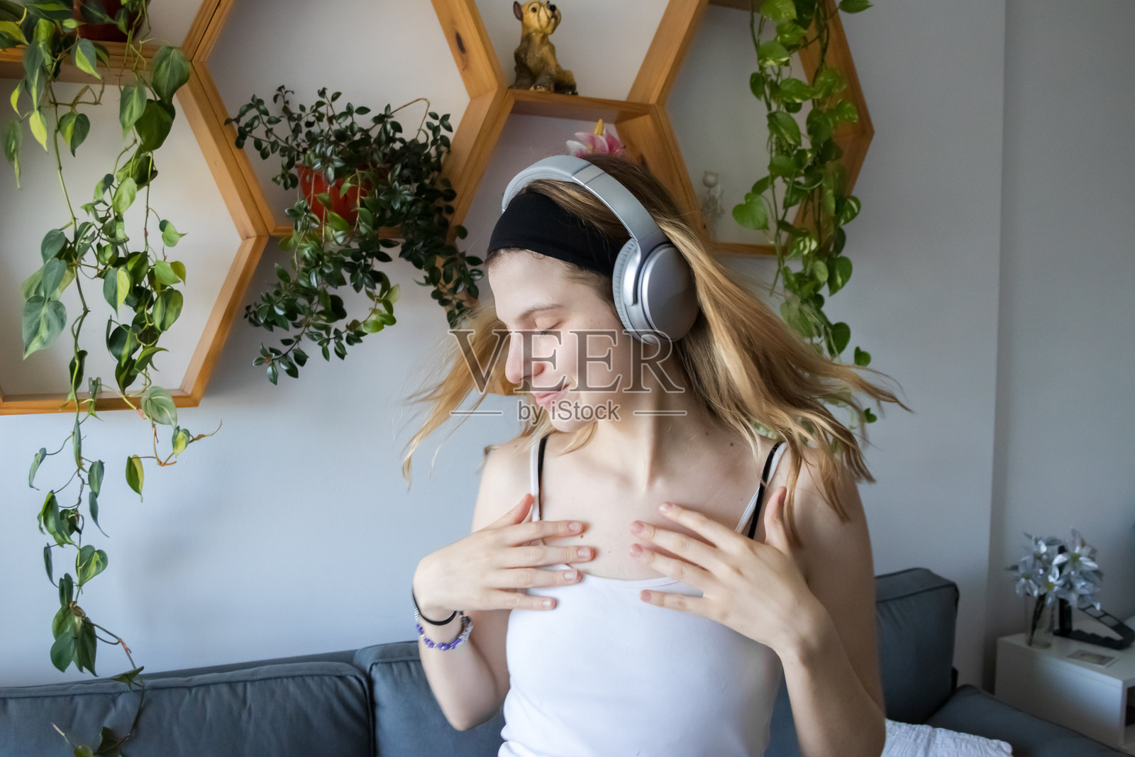 年轻女子，金发，白种人，戴着耳机听音乐，跳舞照片摄影图片