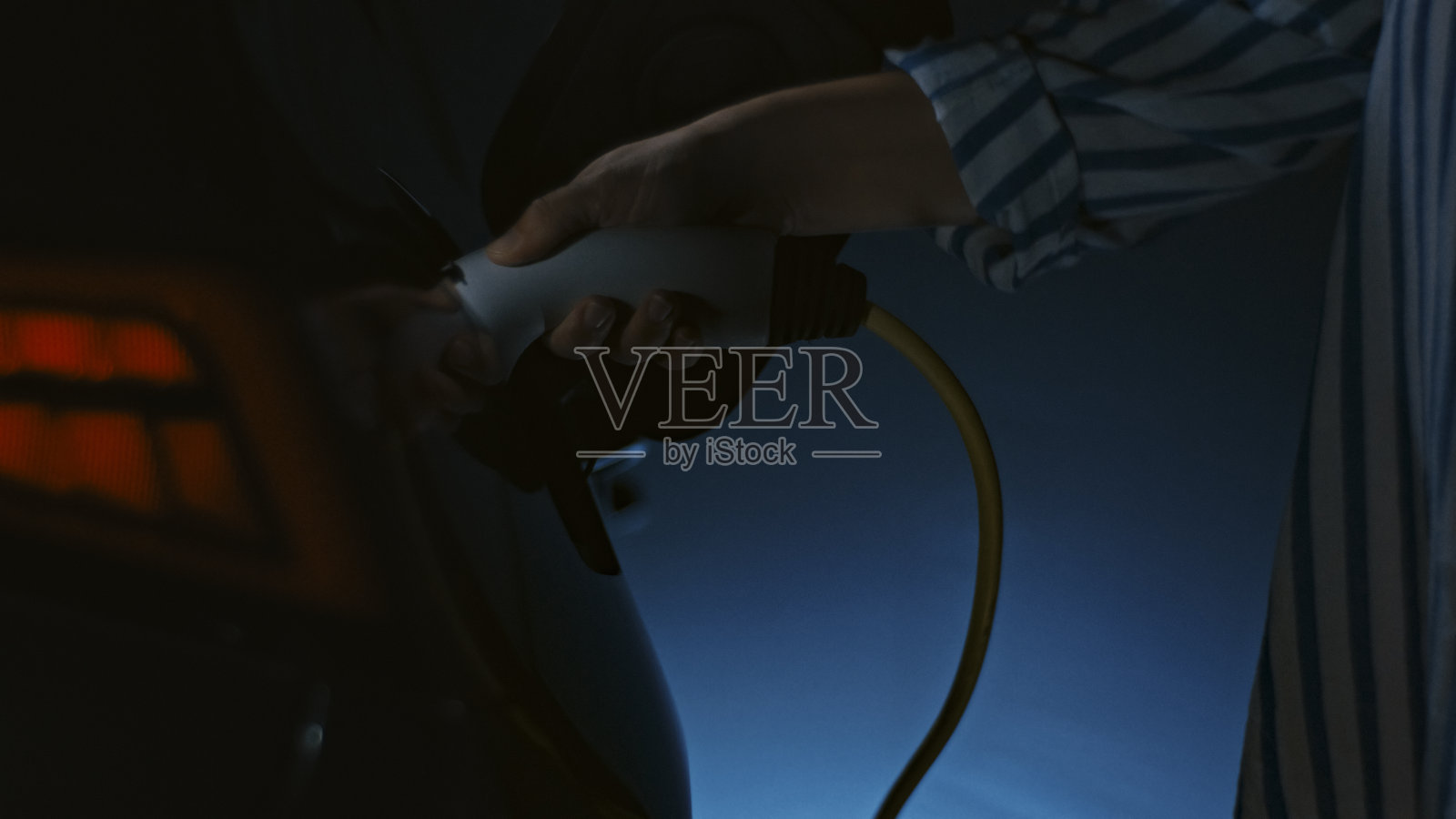 坚定的女性为电动车充电照片摄影图片