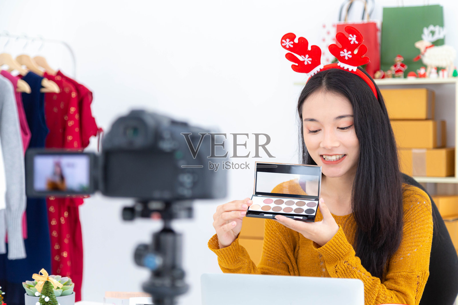 微笑的年轻女子在商店拿着美容产品的肖像照片摄影图片