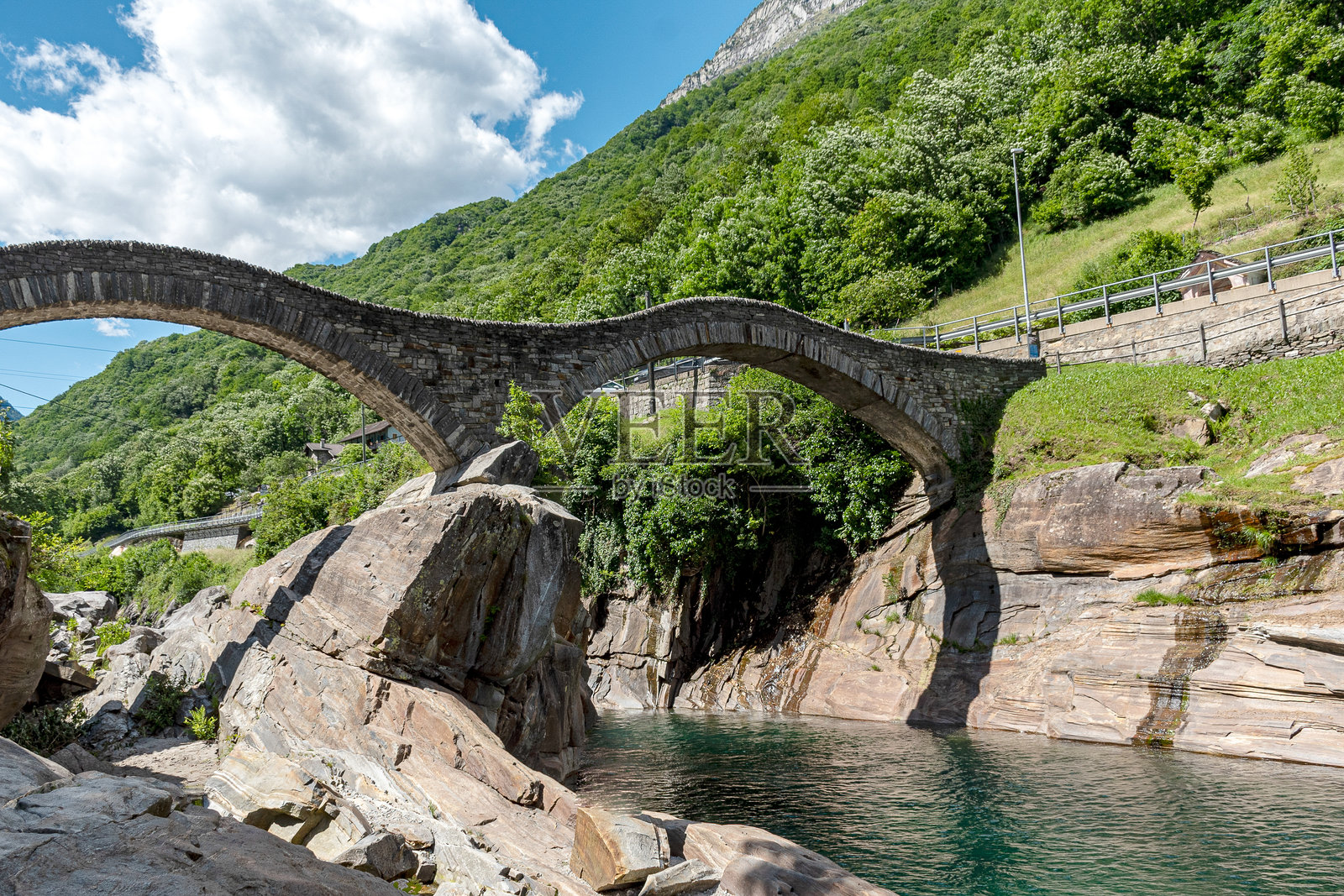 拱桥横跨河流，历史悠久的桥梁，夏季的绿色风景照片摄影图片