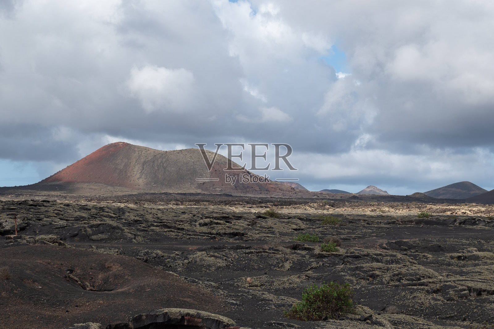 火山景观，拉赫里亚，兰萨罗特，西班牙，加那利群岛，欧洲。火山景观中的葡萄酒区，俯瞰火山。照片摄影图片