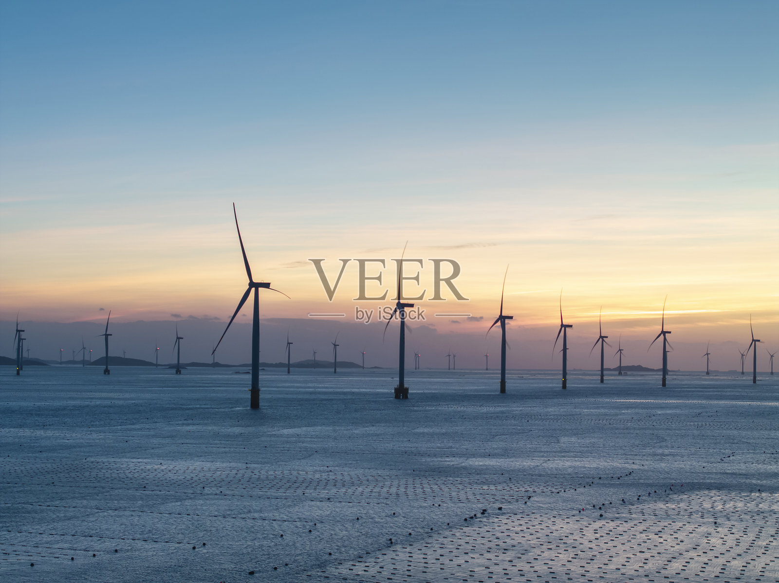 美丽晨空下的海上风力涡轮机照片摄影图片