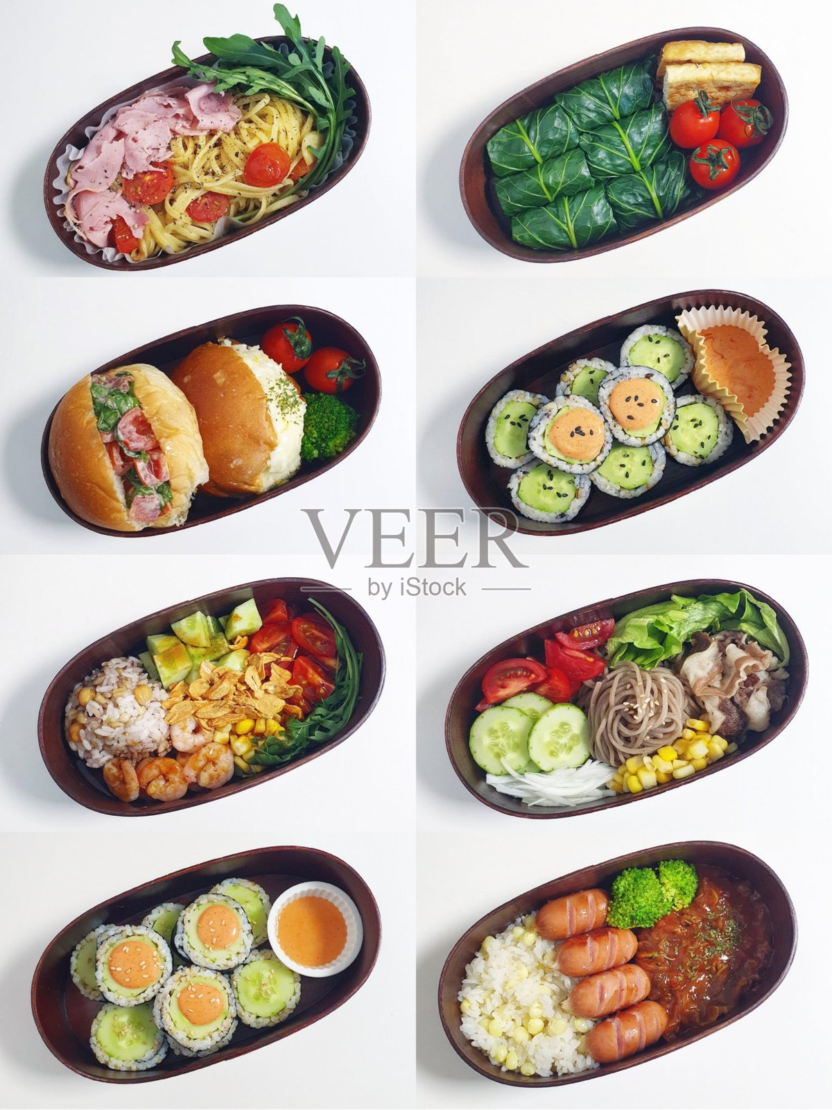 韩式便当，包含米饭、各种配菜、鸡蛋、香肠、蒸西兰花和泡菜。盛放在金属韩式便当盒中。照片摄影图片