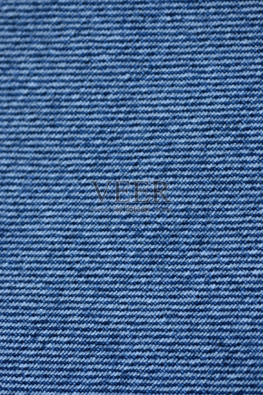 宏观蓝色牛仔布纹理，蓝色牛仔布纹理作为背景的特写照片，从上方拍摄。照片摄影图片