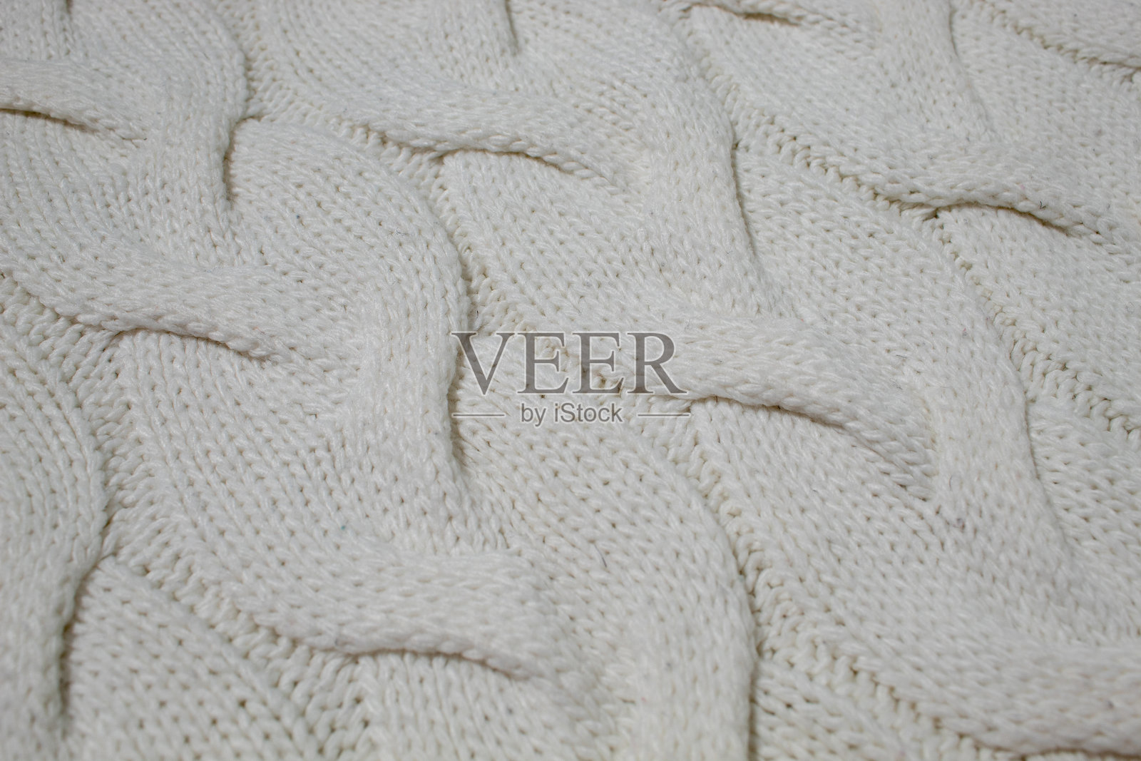 轻质表面上的针织羊毛毛衣，慢时尚。背景纹理。照片摄影图片