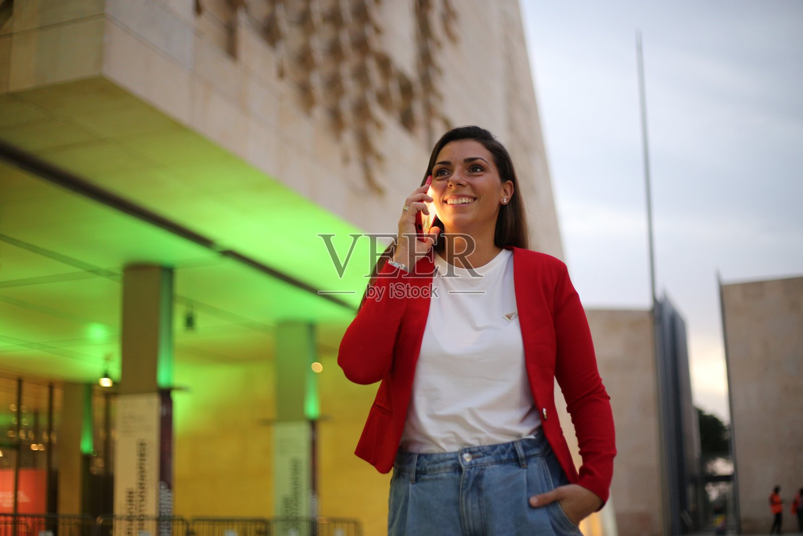 美丽的女性在城市街道上使用手机。照片摄影图片