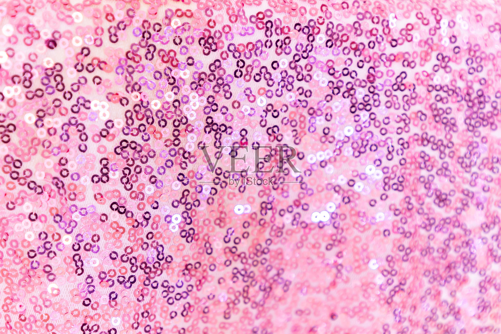 粉色闪亮亮片的节日背景特写，选择性对焦照片摄影图片