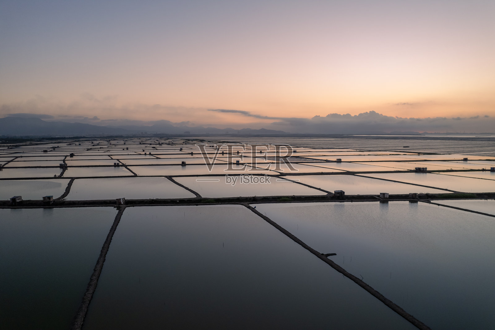 日出时分海边水产养殖池的鸟瞰图照片摄影图片
