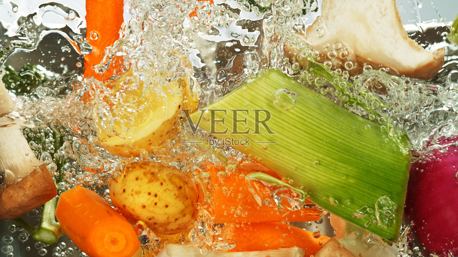 新鲜蔬菜飞溅的定格动作拍摄。照片摄影图片