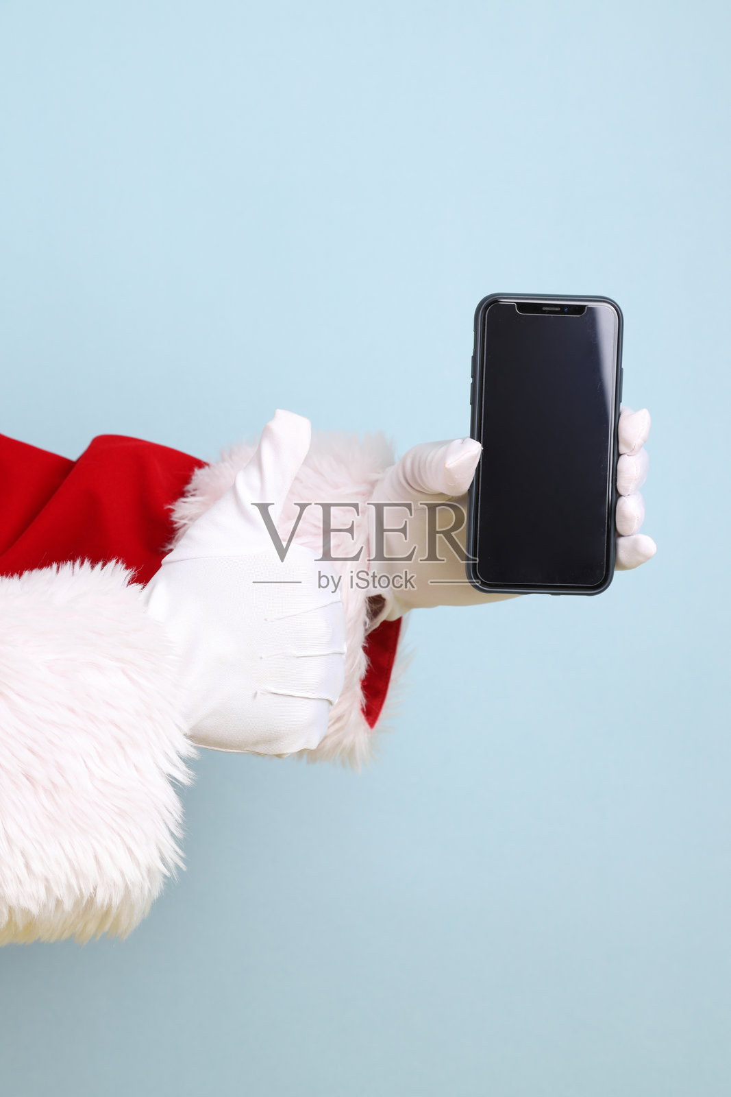 圣诞老人拿着手机照片摄影图片