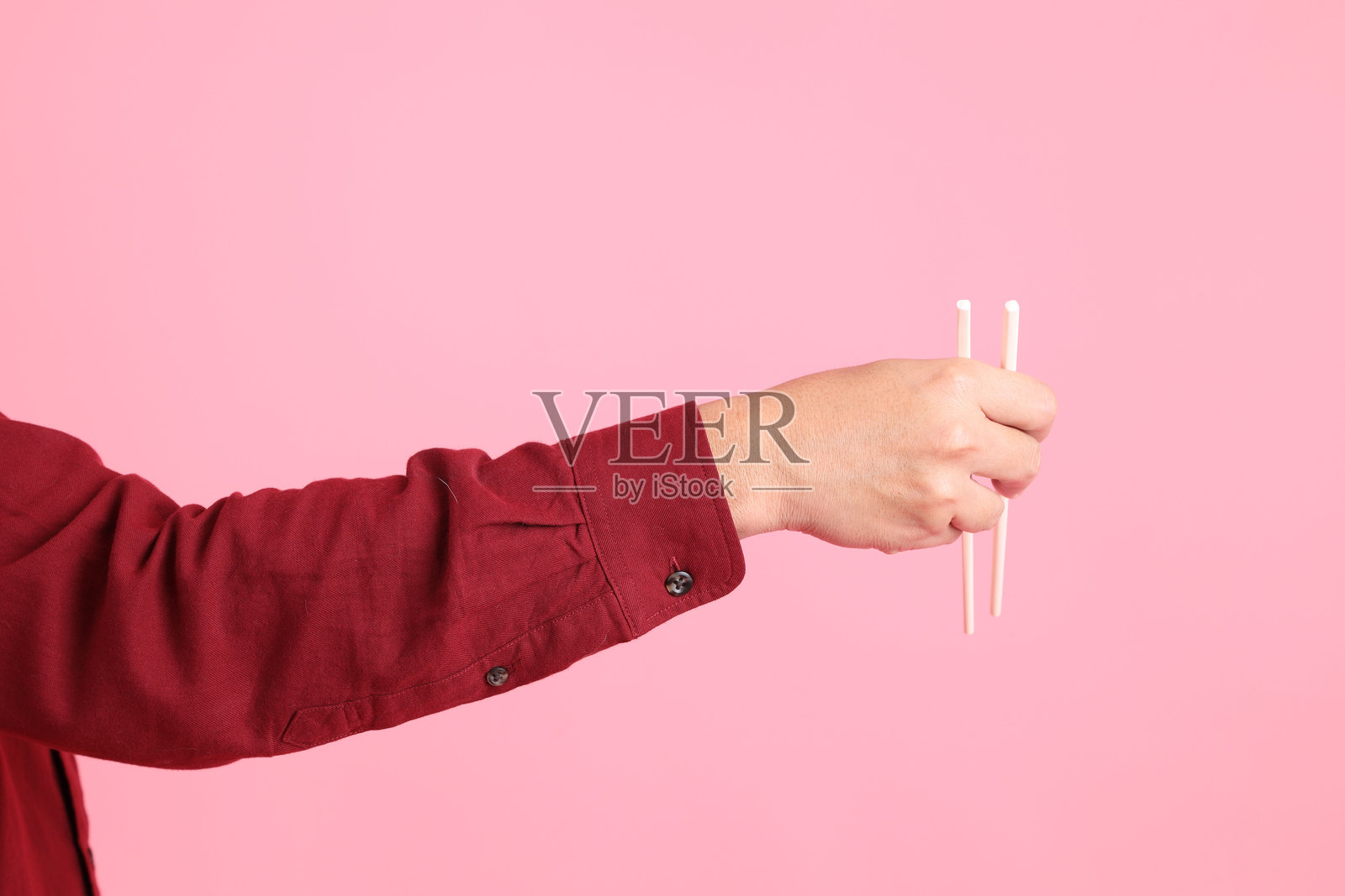 手握塑料筷子照片摄影图片