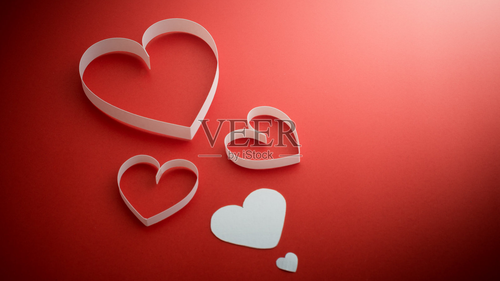 红色背景上的心形纸张特写照片摄影图片
